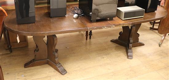 An oak extending dining table W.235cm extended